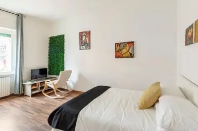 a bedroom with a bed and a desk with a computer at San Giovanni Living House in Rome