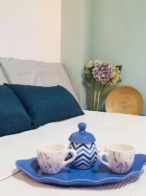 a tray with two cups and a teapot on a bed at La Casetta di Roma in Rome