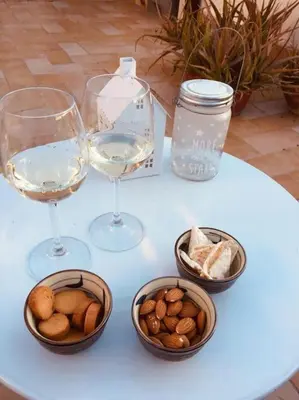 a table with two glasses of wine and bowls of nuts at La Casetta di Roma in Rome