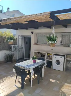 a patio with a table and chairs in front of a house at La Casetta di Roma in Rome
