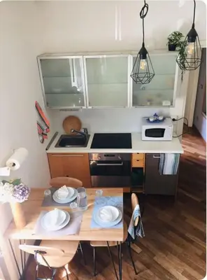 a small kitchen with a table and a stove at La Casetta di Roma in Rome