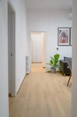 an empty living room with a hard wood floor at Vatican 23 Apartment in Rome