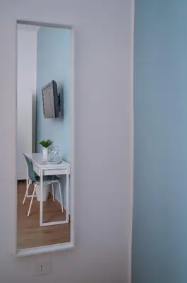 a room with a table and a tv and a window at Vatican 23 Apartment in Rome