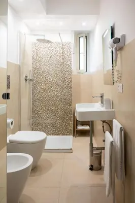 a bathroom with a shower and a toilet and a sink at Maison Aurora in Rome