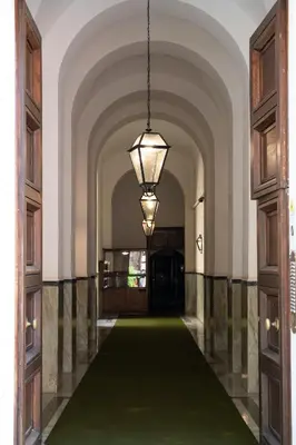 a hallway with a green carpet and a light fixture at Maison Aurora in Rome