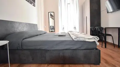 a bedroom with a bed with a blanket on it at Due passi dal cupolone - appartamento al centro in Rome