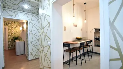 a kitchen with a counter and stools in a room at Due passi dal cupolone - appartamento al centro in Rome
