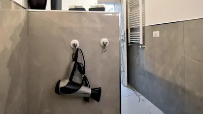 a hair dryer hanging on a wall in a room at Due passi dal cupolone - appartamento al centro in Rome