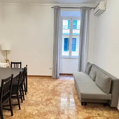 a living room with a couch and a table and a window at Angelico Home in Rome