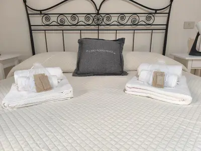 a bed with two towels and a pillow on it at Alloggio Turistico Giotta in Rome