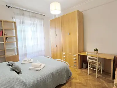 a bedroom with a bed and a desk and a table at Alloggio Turistico Giotta in Rome
