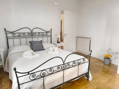 a bedroom with a large white bed with two pillows at Alloggio Turistico Giotta in Rome