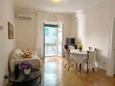 a living room with a table and a dining room at Alloggio Turistico Giotta in Rome