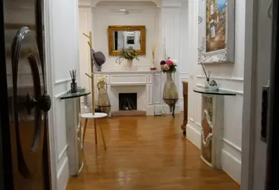 a living room with a fireplace and a mirror at Dimora Vantaggio in Rome