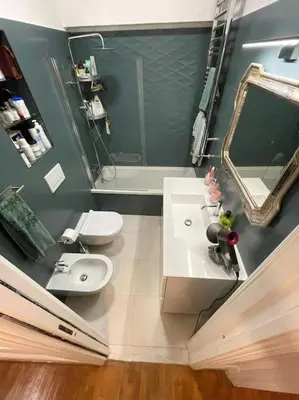 a bathroom with a sink and a toilet and a mirror at Dimora Vantaggio in Rome