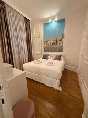 a bedroom with a bed and a painting on the wall at Dimora Vantaggio in Rome