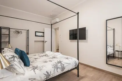 a bedroom with a bed and a mirror at C1 Top Class Apartments, 2 camere delux, max 6 persone distante 15 minuti a piedi da Fontana di Trevi in Rome