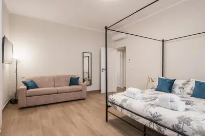 a bedroom with a bed and a couch at C1 Top Class Apartments, 2 camere delux, max 6 persone distante 15 minuti a piedi da Fontana di Trevi in Rome
