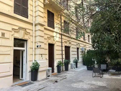 a building with chairs and potted plants on a street at C1 Top Class Apartments, 2 camere delux, max 6 persone distante 15 minuti a piedi da Fontana di Trevi in Rome