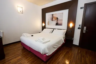 a bedroom with a bed with two towels on it at Gemini Rooms in Rome