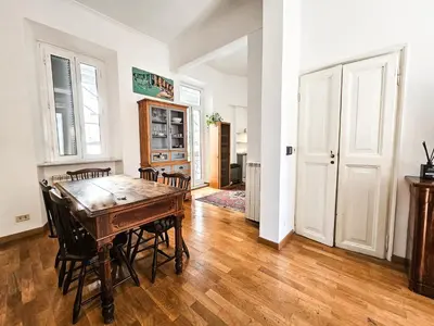 a dining room with a wooden table and chairs at Titus House nelle vicinanze del Colosseo in Rome