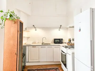 a kitchen with white cabinets and a sink at Titus House nelle vicinanze del Colosseo in Rome