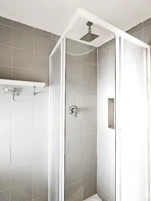 a shower with a glass door in a bathroom at Titus House nelle vicinanze del Colosseo in Rome