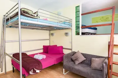 a living room with a bunk bed and a couch at Holiday Home Naiadis in Rome
