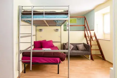 a room with two bunk beds and a couch at Holiday Home Naiadis in Rome