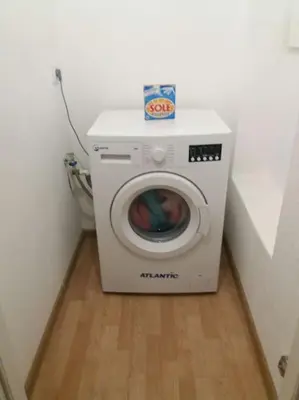 a washing machine with a box on top of it at Holiday Home Naiadis in Rome