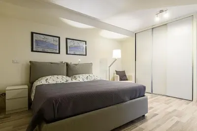 a bedroom with a large bed and a large window at Casa Tiburtina in Rome