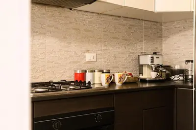 a kitchen with a stove and a counter top at Casa Tiburtina in Rome