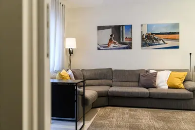 a living room with a couch and paintings on the wall at Casa Tiburtina in Rome