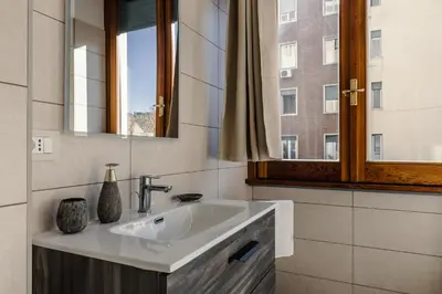 a bathroom with a sink and a mirror at Maison Riboty in Rome