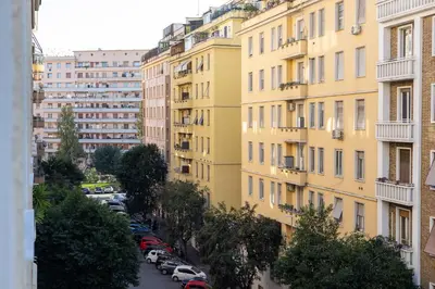 an apartment building with cars parked in a parking lot at Maison Riboty in Rome