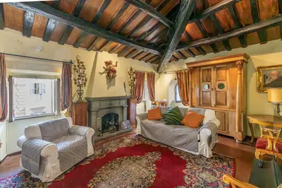 a living room with a couch and a fireplace at Rooma Duplex Campo de Fiori in Rome