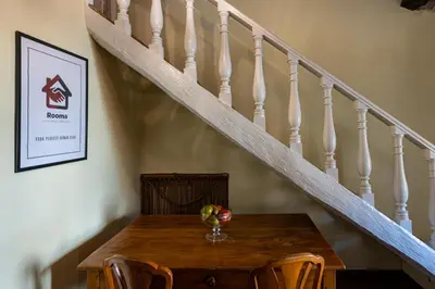 a dining room table with a bowl of fruit on it at Rooma Duplex Campo de Fiori in Rome