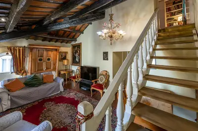 a living room with a staircase and a couch at Rooma Duplex Campo de Fiori in Rome
