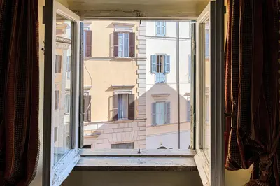 an open window with a view of a building at Rooma Duplex Campo de Fiori in Rome