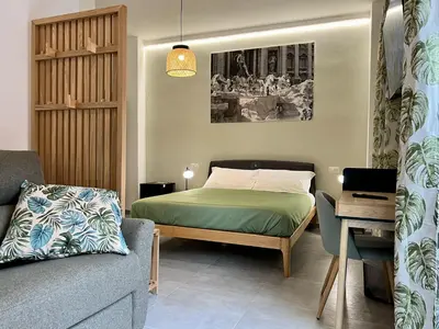 a small bedroom with a bed and a couch at Alma Domus Feriae - Roma in Rome