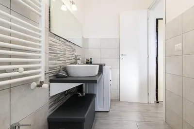 a bathroom with a sink and a mirror at Casa Vacanze Marrucini in Rome