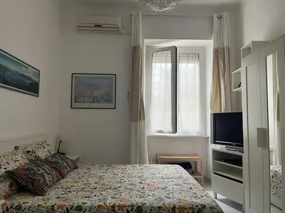 a bedroom with a bed and a flat screen tv at Family Apartment by Metro A Vatican Museums in Rome