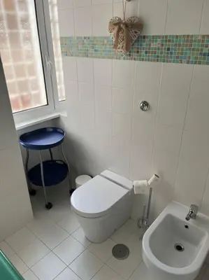 a bathroom with a toilet and a sink at Family Apartment by Metro A Vatican Museums in Rome
