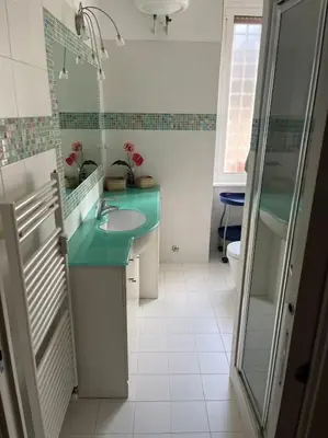 a bathroom with a sink and a shower and a mirror at Family Apartment by Metro A Vatican Museums in Rome