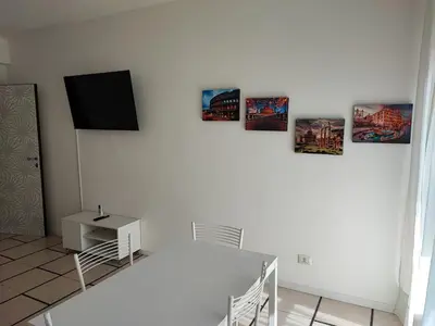 a white room with a tv on a white wall at Al Trilocale Romano Metro A in Rome