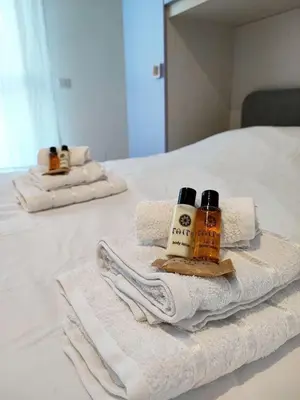 two towels and two bottles of soap on a bed at Al Trilocale Romano Metro A in Rome
