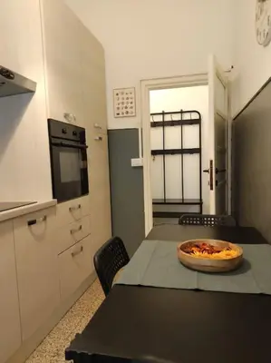 a kitchen with a table with a pizza on it at A casa di Gi in Rome