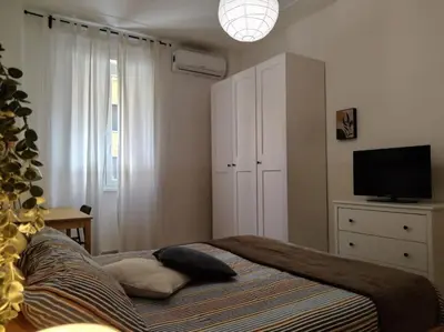 a bedroom with a bed with a television and a cabinet at A casa di Gi in Rome
