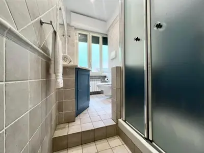 a kitchen with white shelves and a refrigerator at Inn Trastevere Home in Rome