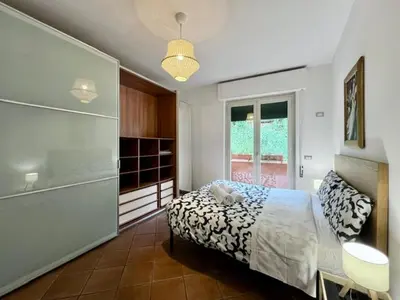 a living room with a tv and a table and a chair at Inn Trastevere Home in Rome